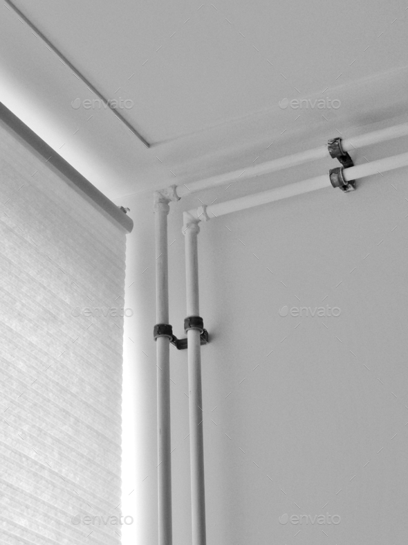 The corner of my room, window, ceiling and heater pipes