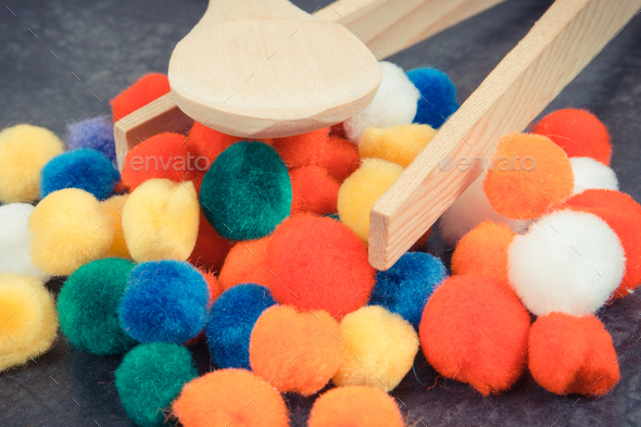 Colorful pompoms using for development of kids motor skills, coordination and logical thinking