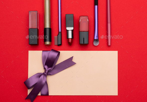 Set of decorative cosmetics near gift coupon - Stock Photo - Images