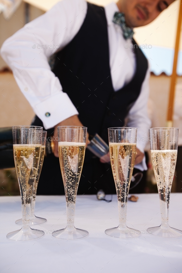 Man poring champagne in glasses Stock Photo by Lemnaouer | PhotoDune