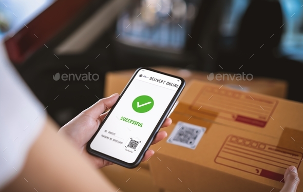 Startup small business, hand using smartphone with scan QR code on cardboard box delivery.