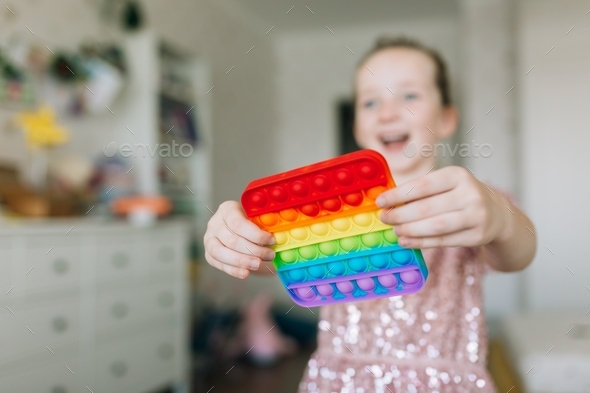 Young kid playing with fidget sensory toy to relieve stress, simple way to be in calm and harmony