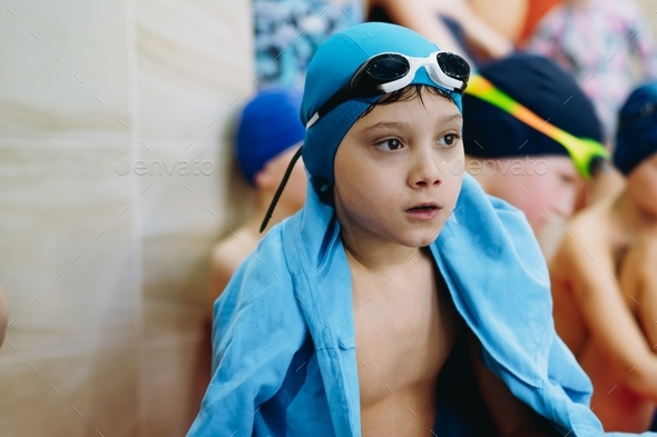 cute little boy waiting for result after swimming competitions