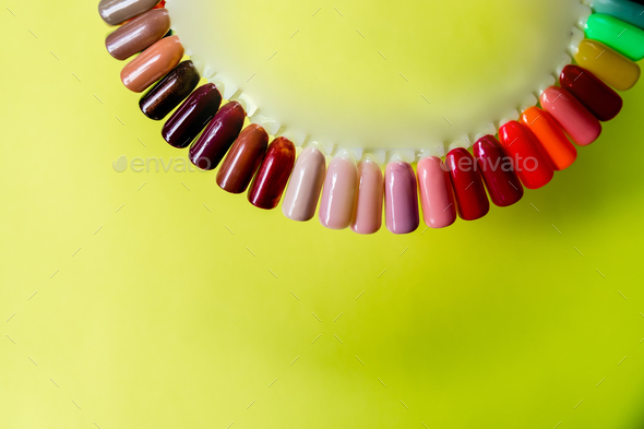 Nail polish samples in different bright colors. Colorful nail lacquer manicure swatches. palette of