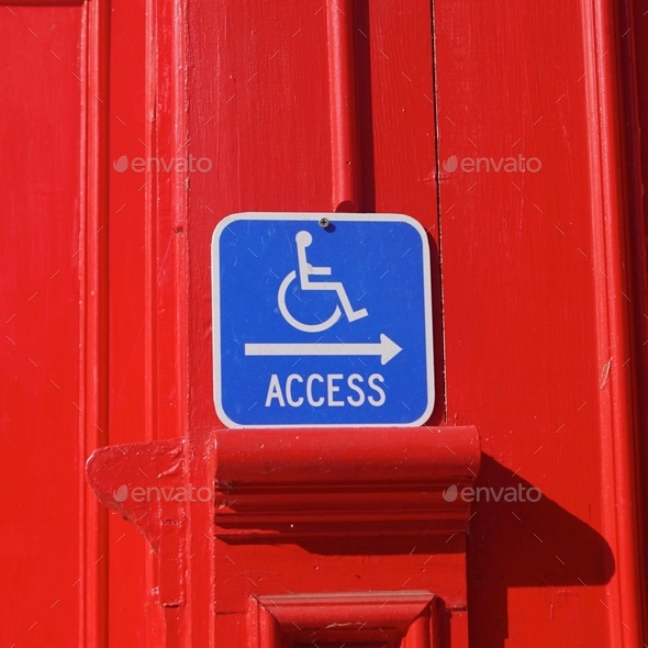 Making the world a better place. Wheelchair accessibility sign on red background.