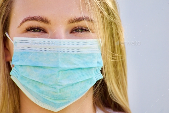 On the Front Lines Everyday- Registered nurse wearing a procedure face mask