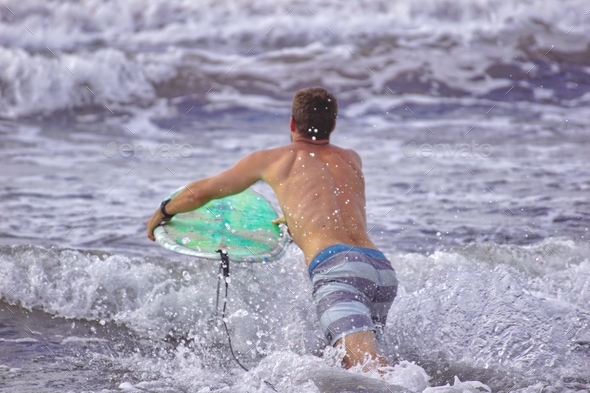 Surfer escaping the days troubles and jumping into an epic surf session