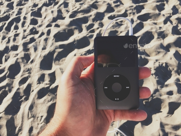 Classic iPod playing music at the beach
