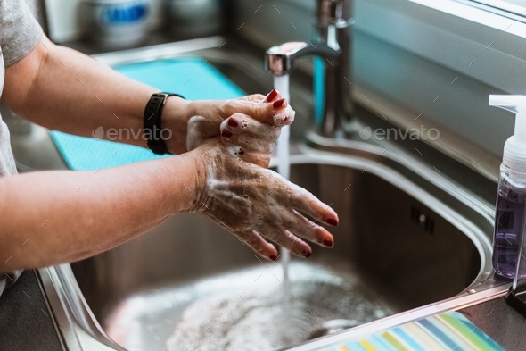 Close-up view of woman washing hands with soap and water from faucet - Stock Photo - Images