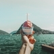 Close-up of hand holding Ice Cream cup against lake landscape - PhotoDune Item for Sale