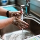 Close-up view of woman washing hands with soap and water from faucet - PhotoDune Item for Sale