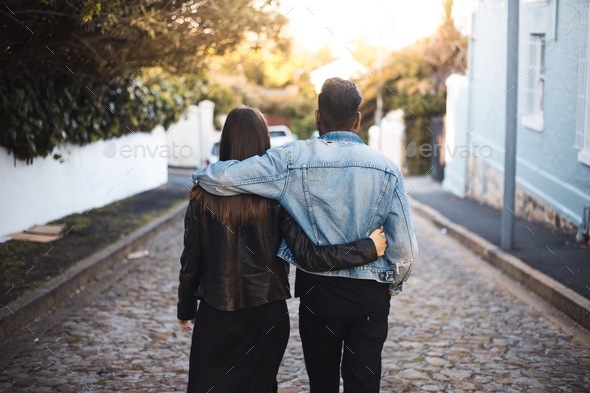Couple walking arm in arm - Stock Photo - Images