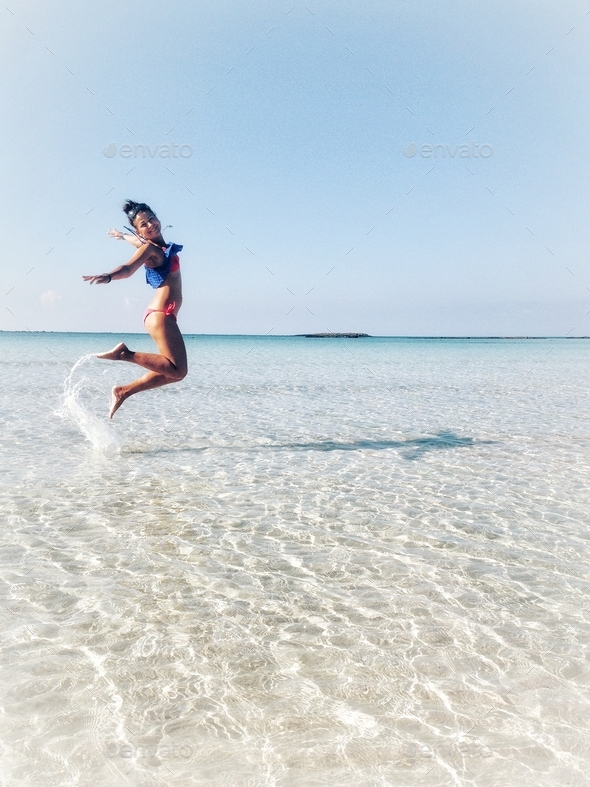 Beautiful girl jumping in the water
 - Stock Photo - Images