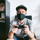 A young guy plays video games during the COVID-19 pandemic - PhotoDune Item for Sale