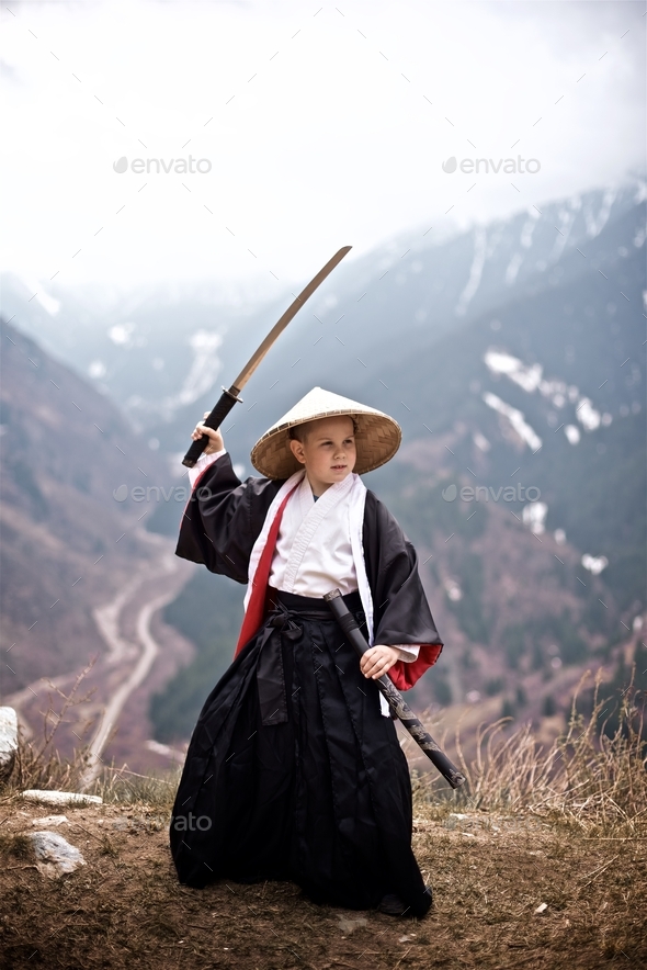 Way of the Samurai Boy dressed as a samurai stands with katana Stock