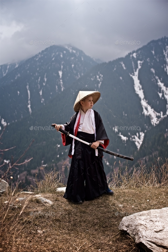 Way of the Samurai Boy dressed as a samurai stands with katana Stock