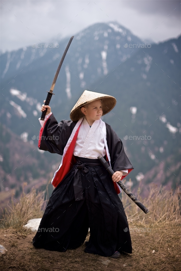 Way of the Samurai Boy dressed as a samurai stands with katana Stock