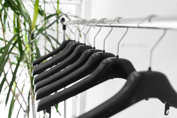 Plastic empty clothes hangers on rack - Stock Photo - Images