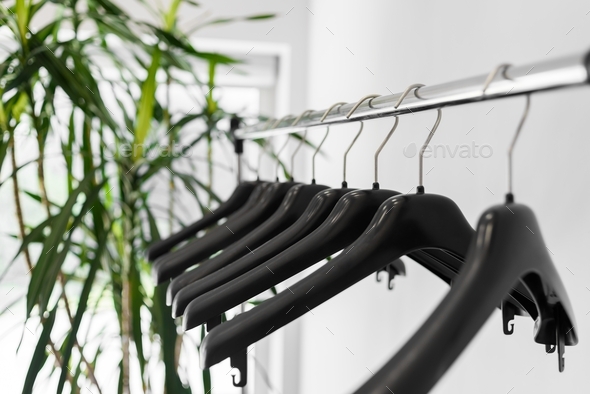 Plastic empty clothes hangers on rack - Stock Photo - Images