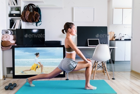 Young fit woman doing yoga stretching exercise