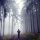 Young man stands on a path in the mist of the forest. - PhotoDune Item for Sale