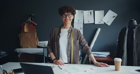 Portrait of Smiling Young Lady Seamstress Looking at Camera Standing in Studio alt