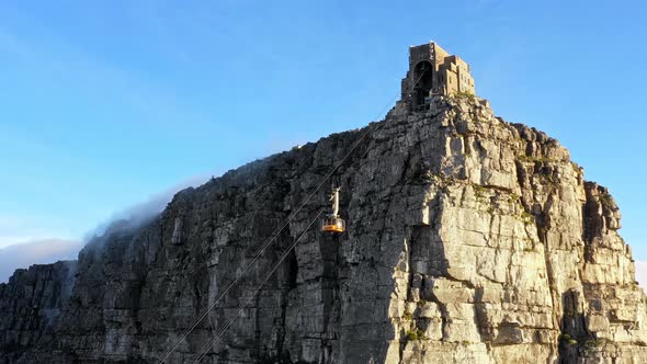 A cable car making its way up the side of a mountain