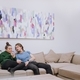 Couple on the couch looking at a mobile phone together - PhotoDune Item for Sale