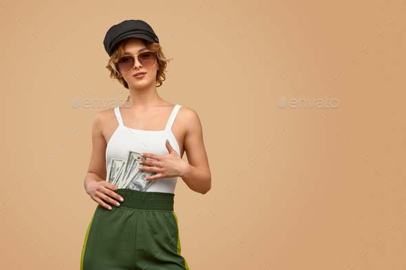 Stylish woman keeping money behind belt