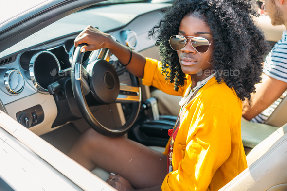selective focus of young stylish african american woman riding car with friend