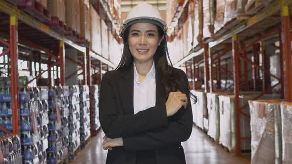 Portrait of Asian manager smiling to camera at warehouse