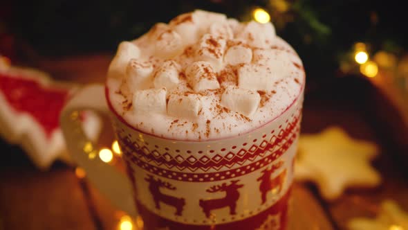 Close-up of a Christmas mug with cocoa with marshmallows and cinnamon