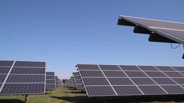 Blue Sunny Sky in the Background of the Rows of Solar Panels at a Power Station alt