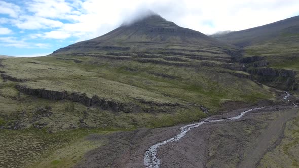 Beautiful landscape in Iceland - a mountain with its top in the cloud alt