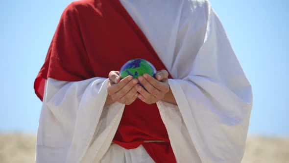 Jesus Holding Earth Planet, Love for World and Self-Sacrifice, Nature Saving alt