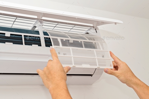 Changing the filter of the air conditioner. Changing filter in air conditioning.