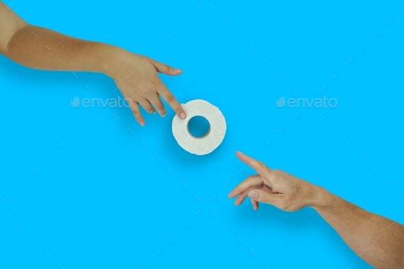 Female hand gives toilet paper roll to male hand on blue background, top view, flat lay