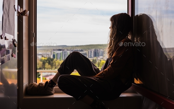 Girl watching out of the window deep in thought