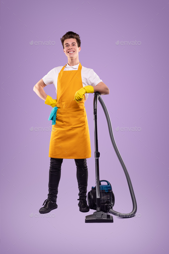 Happy man in apron with vacuum cleaner