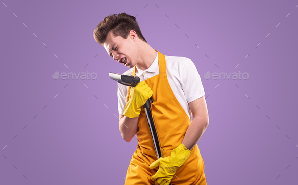 Young man singing into vacuum cleaner