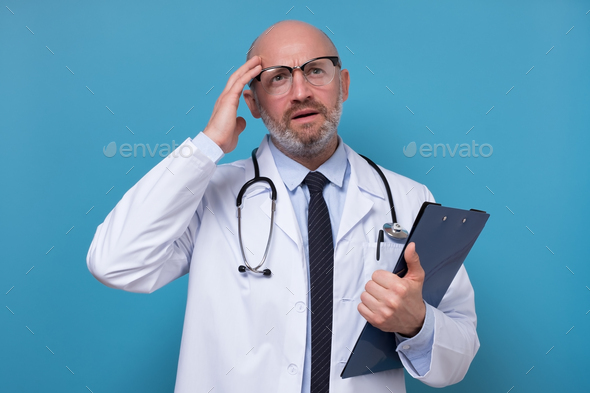 Doctor thinking about diagnosis being confused with medical exam results