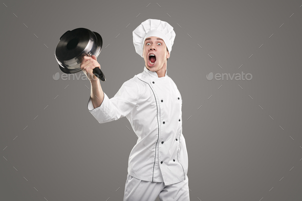 Crazy chef screaming loudly with raised pan