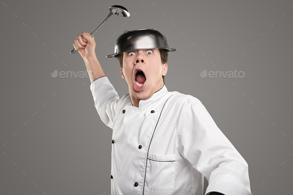 Crazy chef with ladle screaming at camera