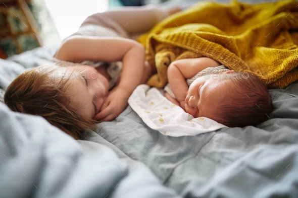 cute baby siblings sleep together, newborn baby and toddler older sister, sibling relationship