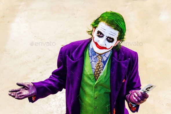 A portrait of a male cosplayer dressed as the joker from the Batman dark Knight movie at a comic con