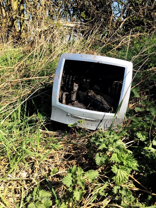 old technology out of date computer, TV dumped in wasteland in a fly tipping concept with copy space