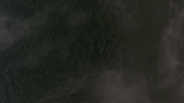 River or Reservoir Freezes in Late Autumn, Steam Comes From the Water alt