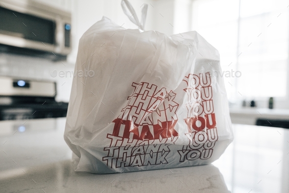 bag of takeout food to go sitting on a countertop in a kitchen