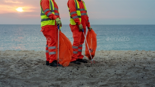 Beautiful sunrise; cleaning: beach; environment teamwork; ocean: sun: environmental: volunteers