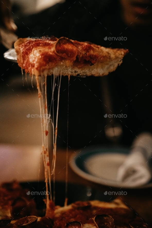 Cheese pull slice pizza eating dining out restaurant gooey yummy delicious moody pepperoni hot pie